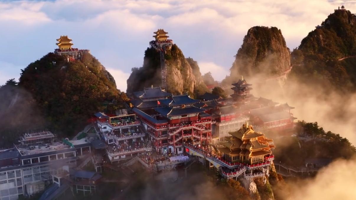 Golden sunlight bathes Laojun Mountain in a sea of clouds