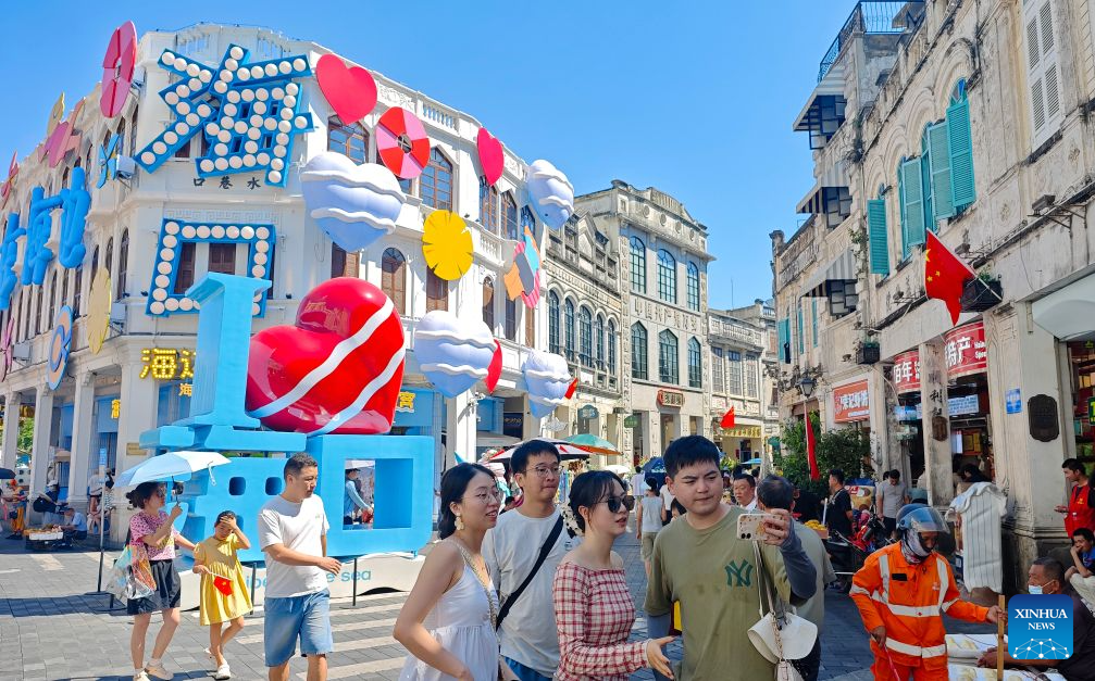 Tourists visit Qilou Old Street in Haikou, south China's Hainan Province, Oct. 1, 2026.  During the first National Day holiday since the launch of the island-wide special customs operations at Hainan Free Trade Port (FTP), the tropical island has offered visitors from home and abroad a diverse range of experiences -- from duty-free shopping and local food to historic neighborhoods and the distinctive lifestyle of fishing communities. (Xinhua/Guo Cheng)