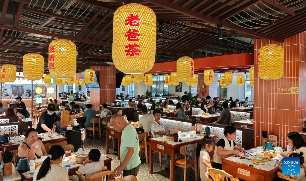 People dine at a local tea house in Haikou, south China's Hainan Province, Oct. 1, 2026.  During the first National Day holiday since the launch of the island-wide special customs operations at Hainan Free Trade Port (FTP), the tropical island has offered visitors from home and abroad a diverse range of experiences -- from duty-free shopping and local food to historic neighborhoods and the distinctive lifestyle of fishing communities. (Xinhua/Guo Cheng)