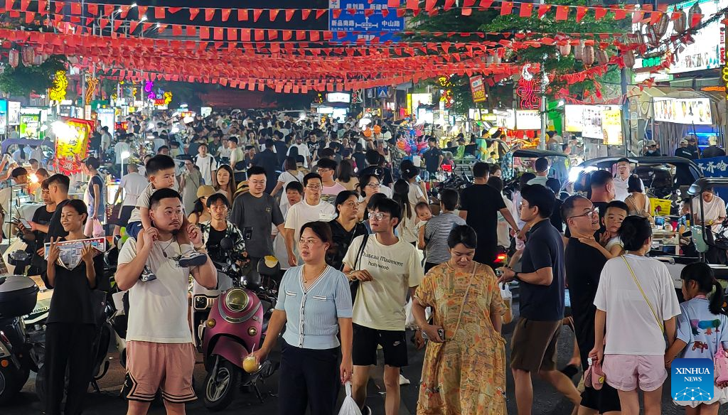 This photo taken on Oct. 1, 2026 shows the bustling night market in Xincun Port of Lingshui Li Autonomous County, south China's Hainan Province.  During the first National Day holiday since the launch of the island-wide special customs operations at Hainan Free Trade Port (FTP), the tropical island has offered visitors from home and abroad a diverse range of experiences -- from duty-free shopping and local food to historic neighborhoods and the distinctive lifestyle of fishing communities. (Xinhua/Guo Cheng)