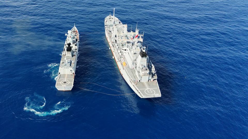 Warships conduct alongside replenishment at sea