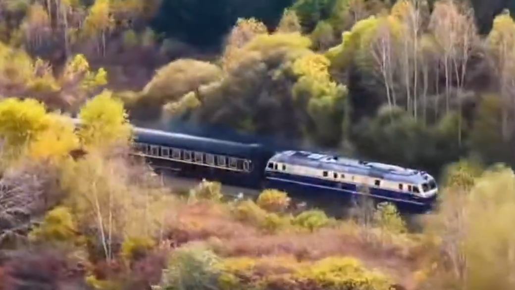Train winds through fall foliage of Lesser Khingan Mountains