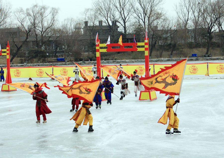 People wearing Qing dresses skate on ice. (PhotoChina/ Xiao Dong)