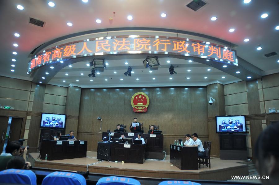 Photo taken on July 15, 2013 shows the judge reading the final ruling in the The Hunan Provincial People's High Court in Changsha, capital of central China's Hunan Province. The Hunan Provincial People's High Court on Monday ordered the Yongzhou municipal re-education through labor commission to pay Tang Hui 2,941 yuan (478 U.S. dollars) in compensation for infringing upon her personal freedom and causing mental damages. The 40-year-old mother appealed to the high court in April after the Yongzhou Intermediate People's Court denied her request for an apology and compensation from the re-education through labor commission. Tang was put into the labor camp after she publicly petitioned for harsher punishments for those found guilty of raping her daughter and forcing her into prostitution. (Xinhua/Long Hongtao) 